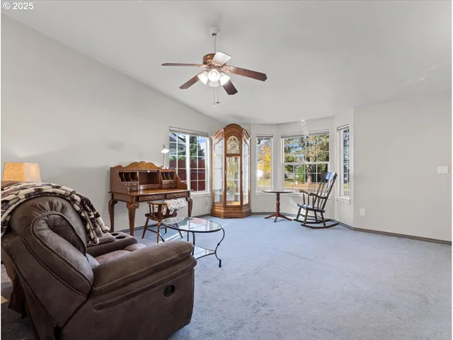 a bedroom with furniture and a large window