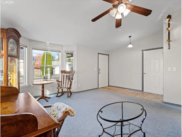 a view of a livingroom with furniture and a window