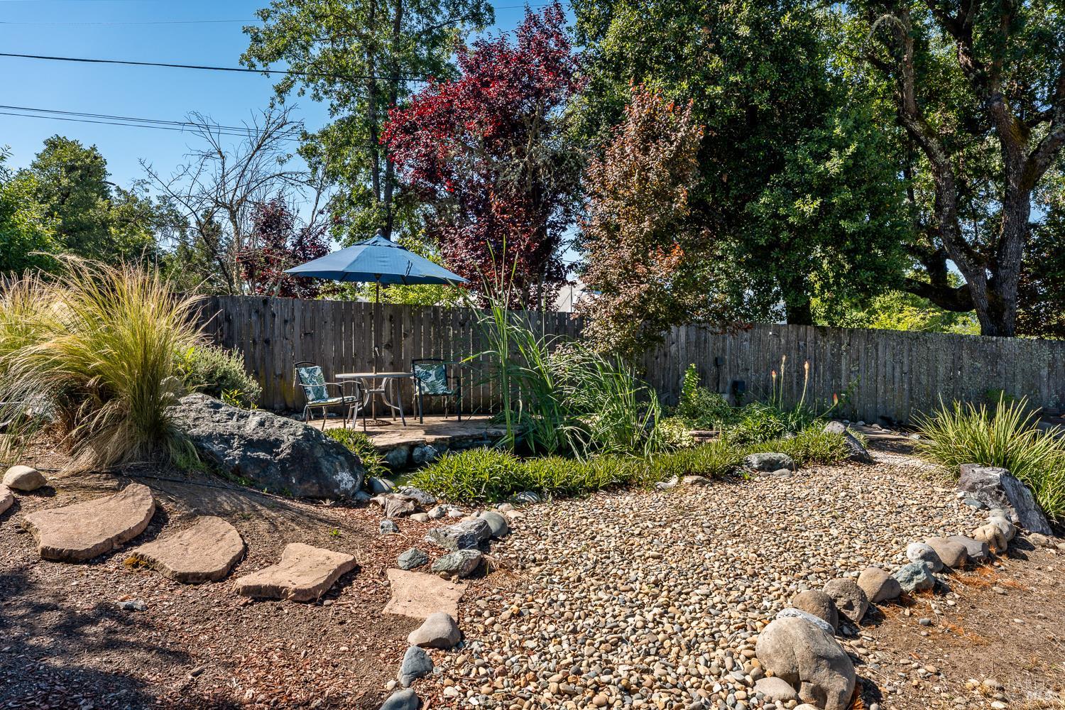 2260 Old River Road Ukiah, CA 95482 - Photo 12 of 29 a view of a backyard with plants and a patio