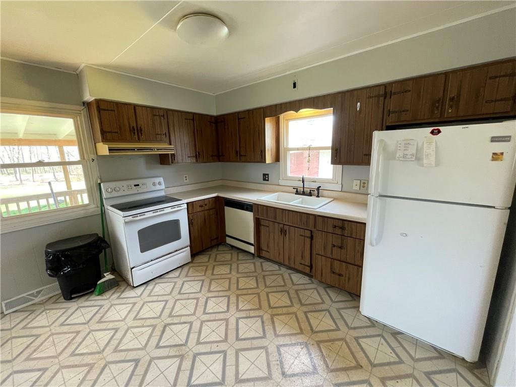 2711 Old Rte 18 Wampum, PA 16157 - Photo 4 of 23 a kitchen with a stove a refrigerator and a sink