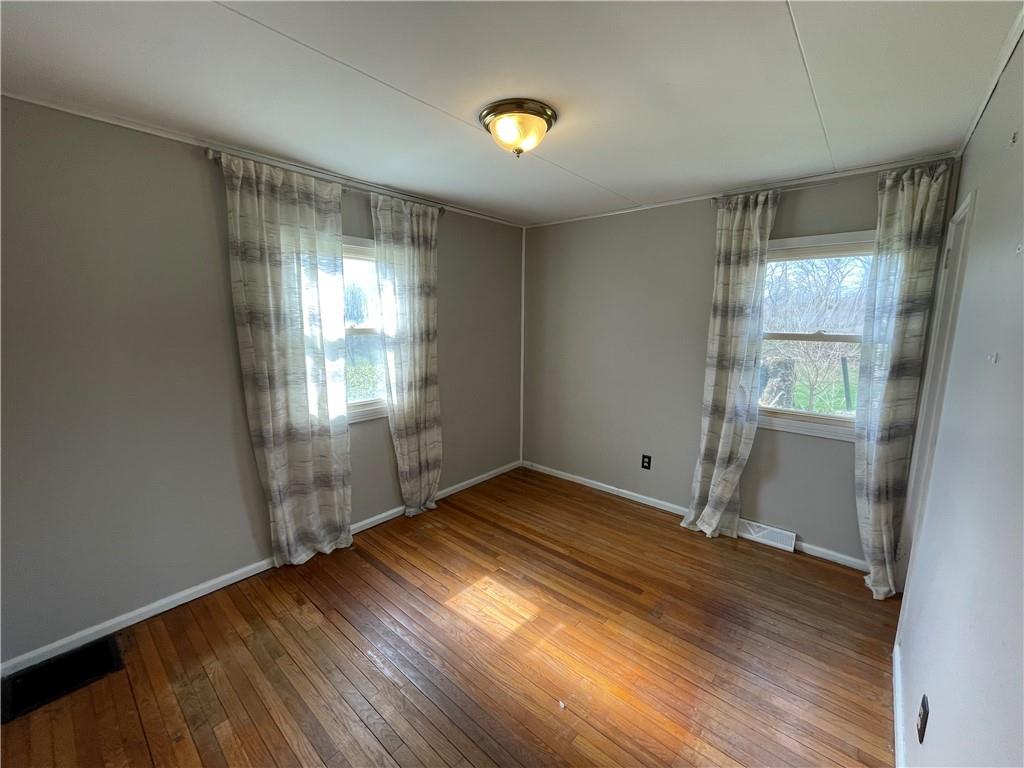 2711 Old Rte 18 Wampum, PA 16157 - Photo 10 of 23 an empty room with wooden floor and windows
