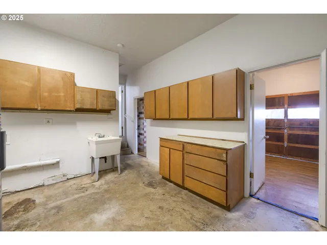a kitchen with stainless steel appliances a stove and cabinets