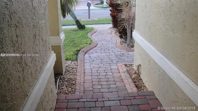 a view of a pathway with a yard