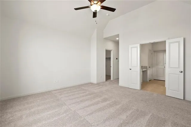 a view of an empty room with a ceiling fan