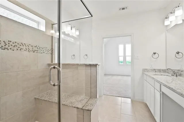 a bathroom with a shower and a sink