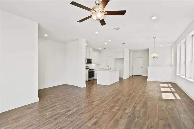 a view of a kitchen with wooden floor and a kitchen