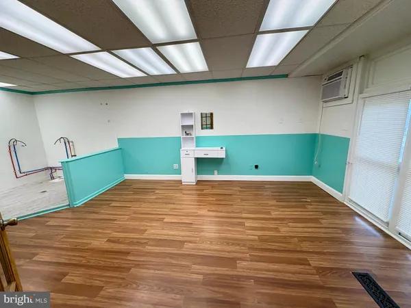 a room with wooden floor and window