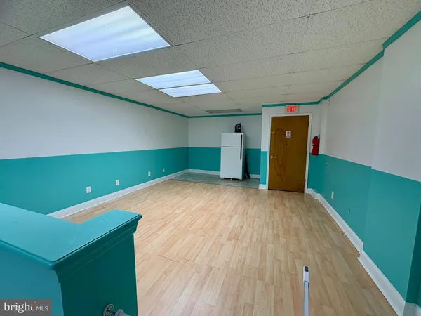 a room with pool table and a kitchen view