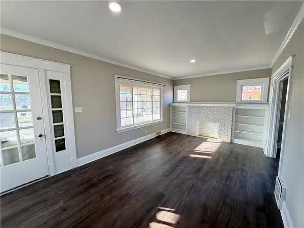 wooden floor in an empty room with a window