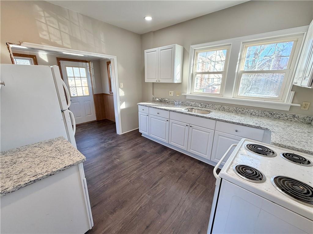 320 Reis Street New Castle, PA 16101 - Photo 8 of 28 a kitchen with granite countertop white cabinets and white appliances