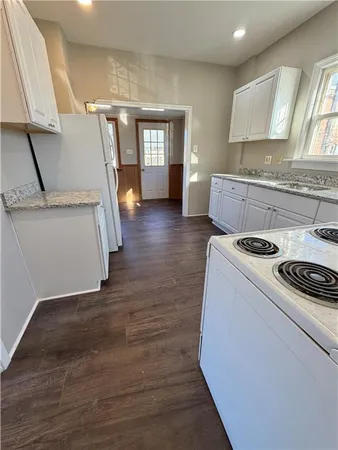 a kitchen with a sink a stove and cabinets