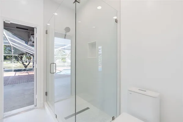 a bathroom with a glass shower door