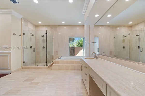 a spacious bathroom with a granite countertop sink a shower and a bathtub