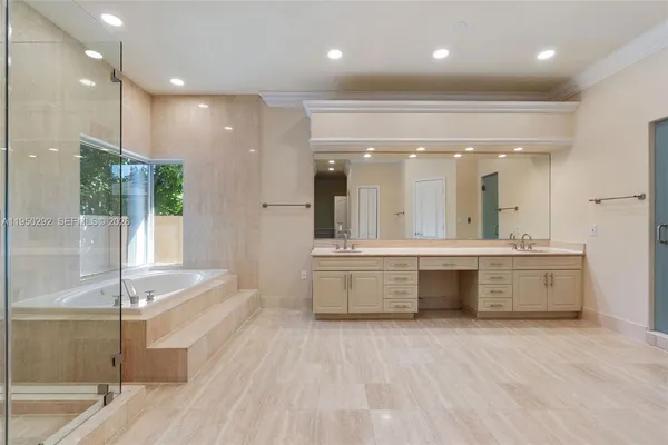a large bathroom with a large tub and sink