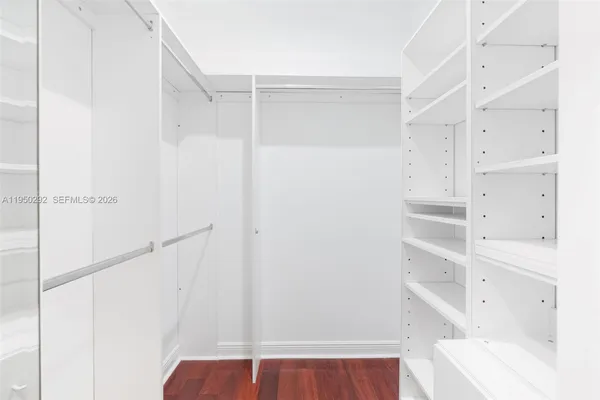 a view of walk in closet with empty racks