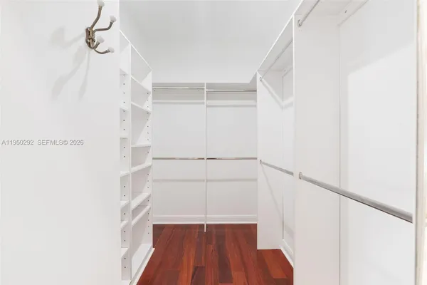 a view of walk in closet with empty racks
