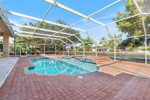a view of a swimming pool with a patio