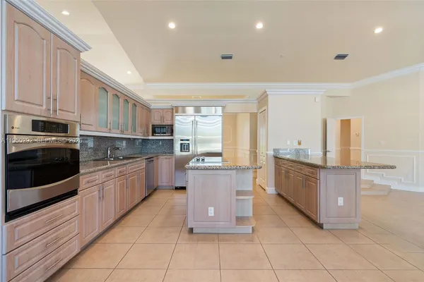 a kitchen with stainless steel appliances granite countertop a stove and a refrigerator