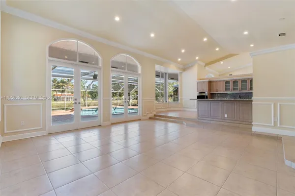 a view of a kitchen with furniture and an empty room