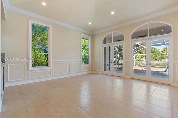 a view of an entryway with wooden floor and garden