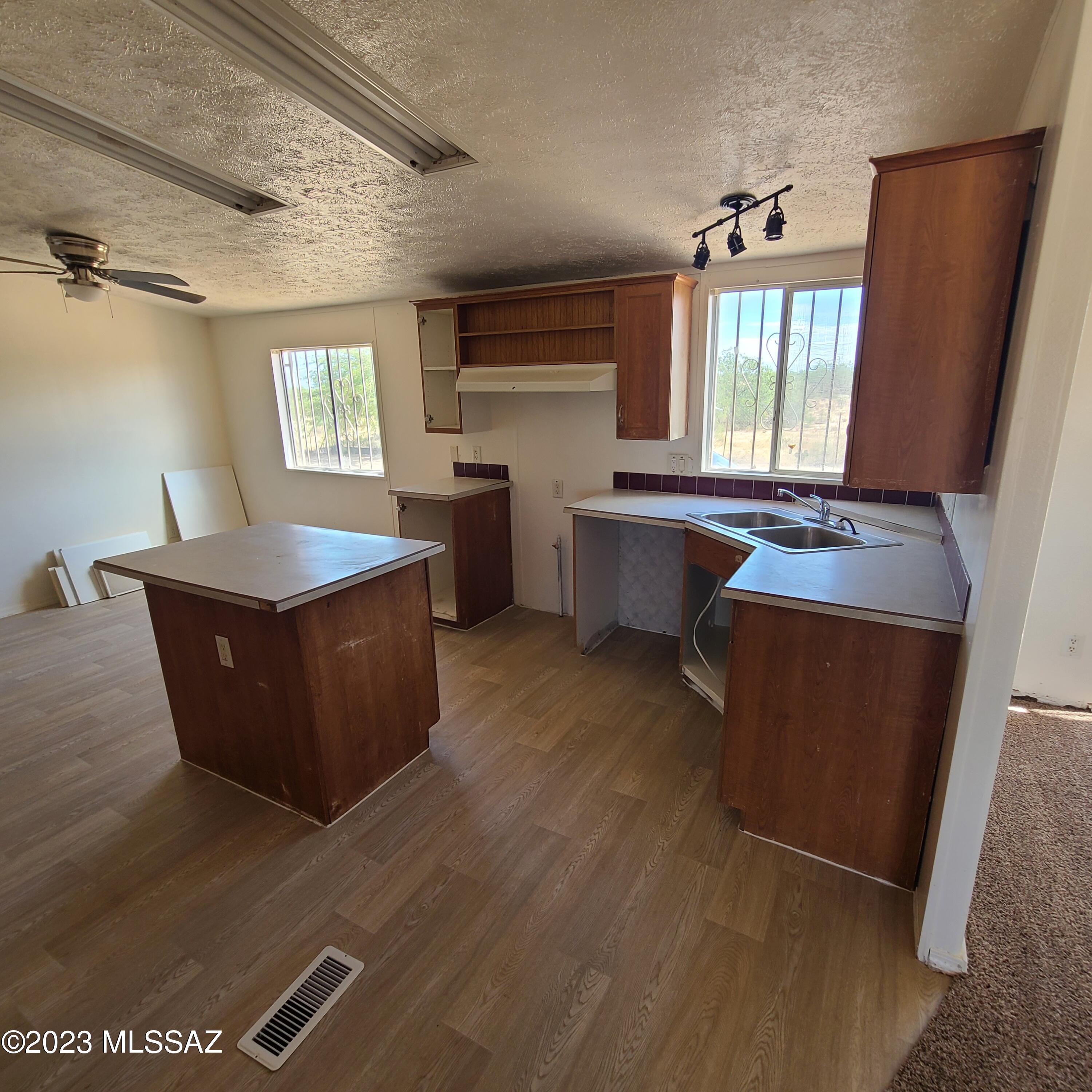 8896 South Marstellar Road Tucson, AZ 85736 - Photo 10 of 39 a kitchen with sink cabinets and window