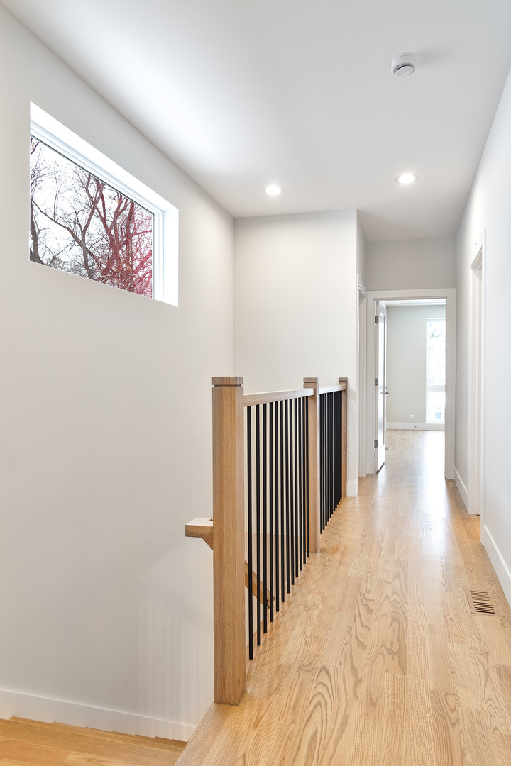 3013 North Normandy Avenue Chicago, IL 60634 - Photo 19 of 26 a view of a hallway with paintings on the wall
