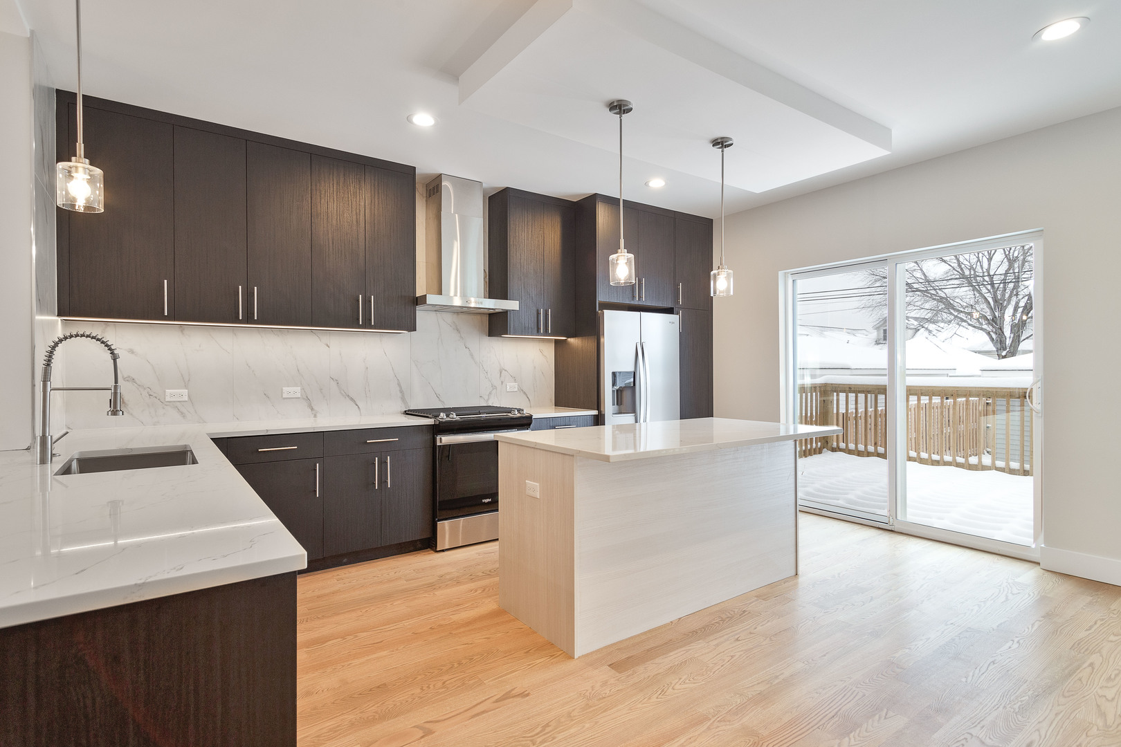 3013 North Normandy Avenue Chicago, IL 60634 - Photo 2 of 26 a large kitchen with stainless steel appliances kitchen island granite countertop a sink and a stove
