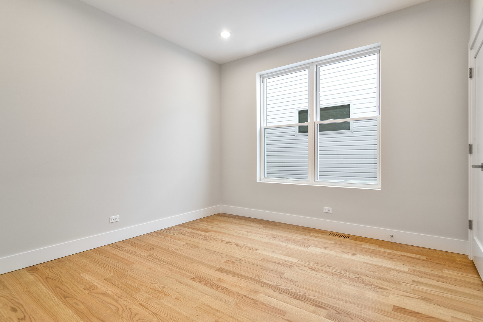 3013 North Normandy Avenue Chicago, IL 60634 - Photo 22 of 26 wooden floor in an empty room with a window