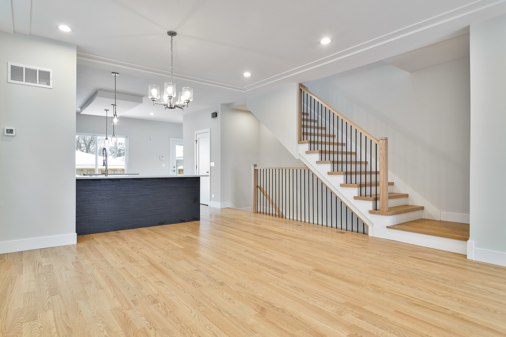 3013 North Normandy Avenue Chicago, IL 60634 - Photo 6 of 26 a view of a room with wooden floor and staircase