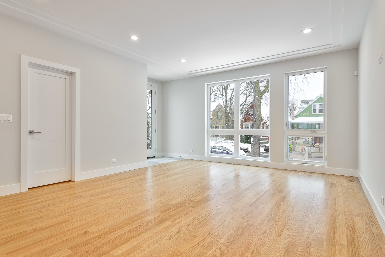 3013 North Normandy Avenue Chicago, IL 60634 - Photo 8 of 26 a view of an empty room with wooden floor and a window