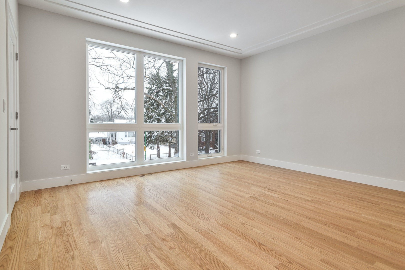 3013 North Normandy Avenue Chicago, IL 60634 - Photo 10 of 26 a view of an empty room with wooden floor and a window