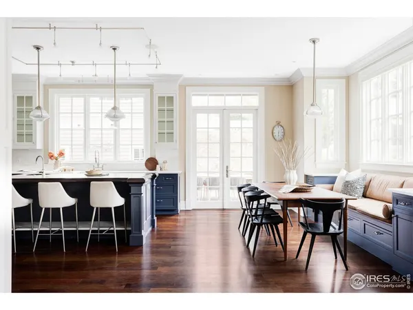 a dining room with furniture a chandelier and wooden floor