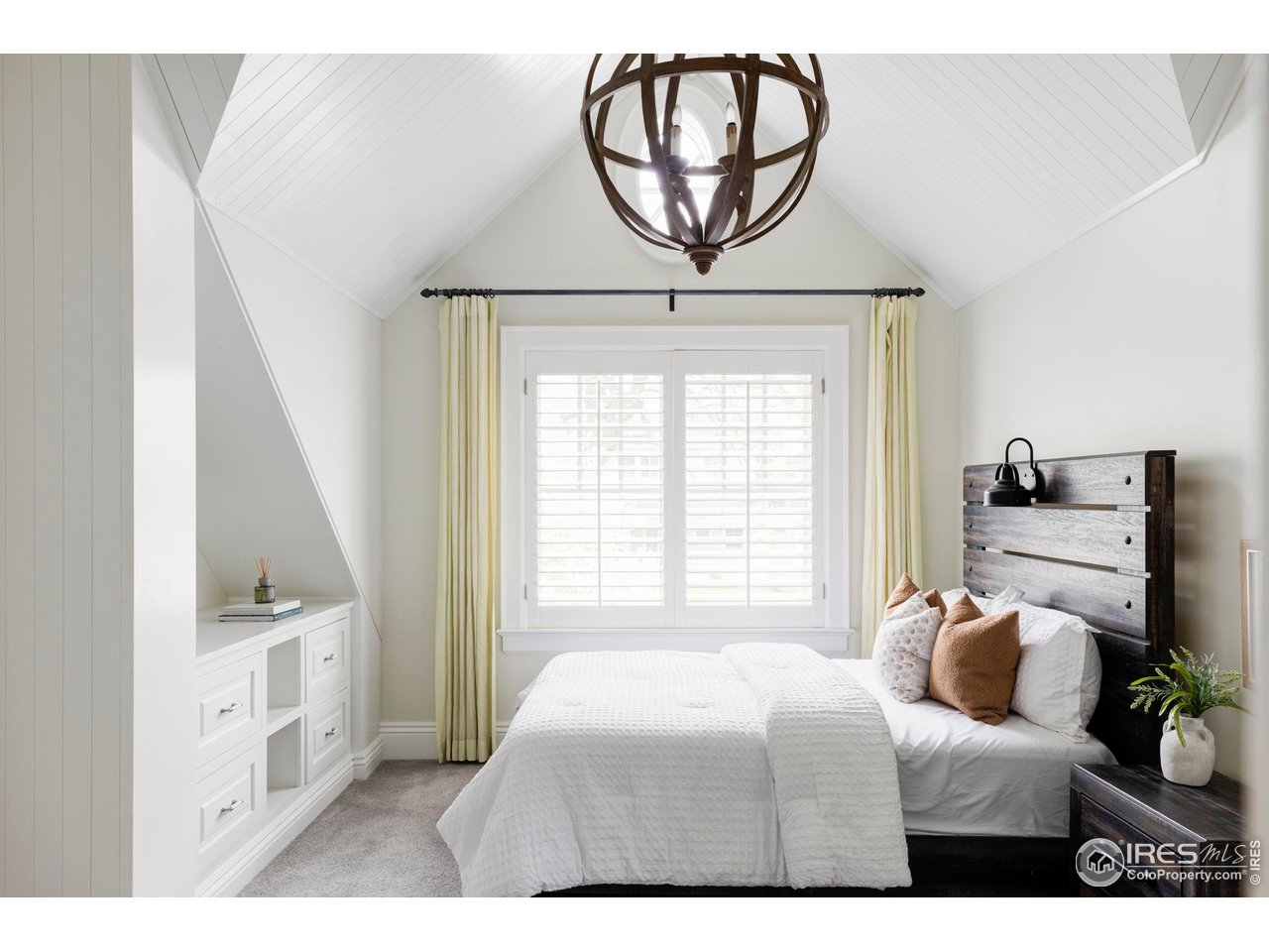 3189 5th Street Boulder, CO 80304 - Photo 19 of 37 a bedroom with a bed and a chandelier