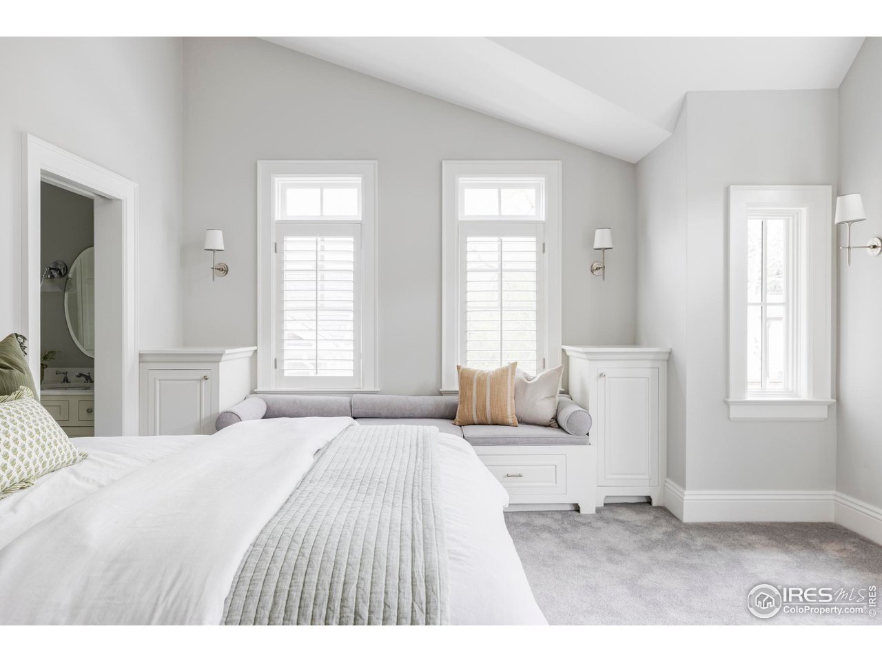 3189 5th Street Boulder, CO 80304 - Photo 24 of 37 a bedroom with a bed a mirror and windows