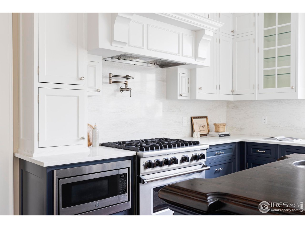 3189 5th Street Boulder, CO 80304 - Photo 9 of 37 a kitchen with stainless steel appliances a stove a white cabinets and a refrigerator