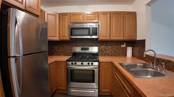 a kitchen with a refrigerator sink and microwave