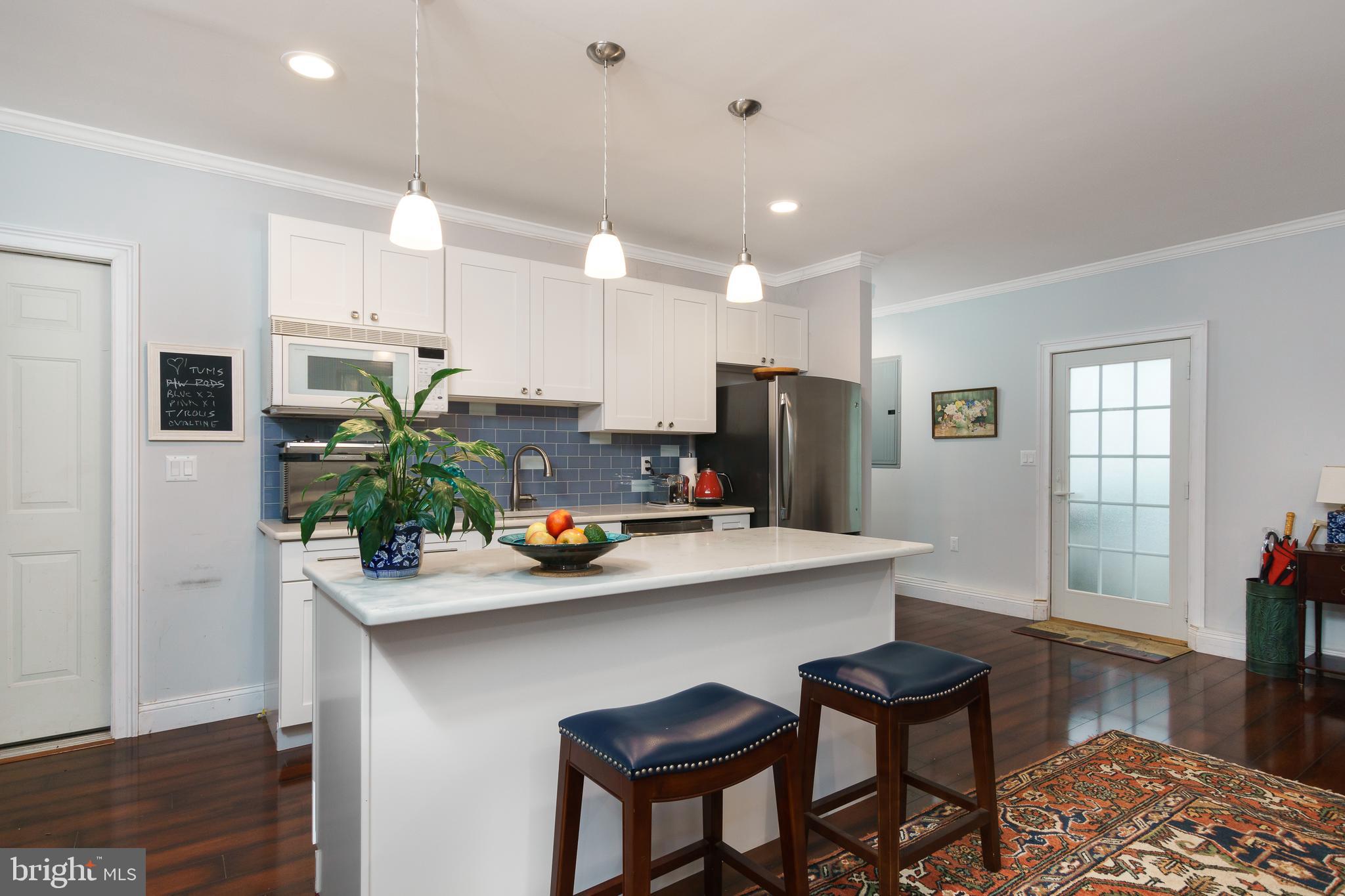50 Skillman Road Skillman, NJ 08558 - Photo 23 of 31 a kitchen with a sink a refrigerator and chairs