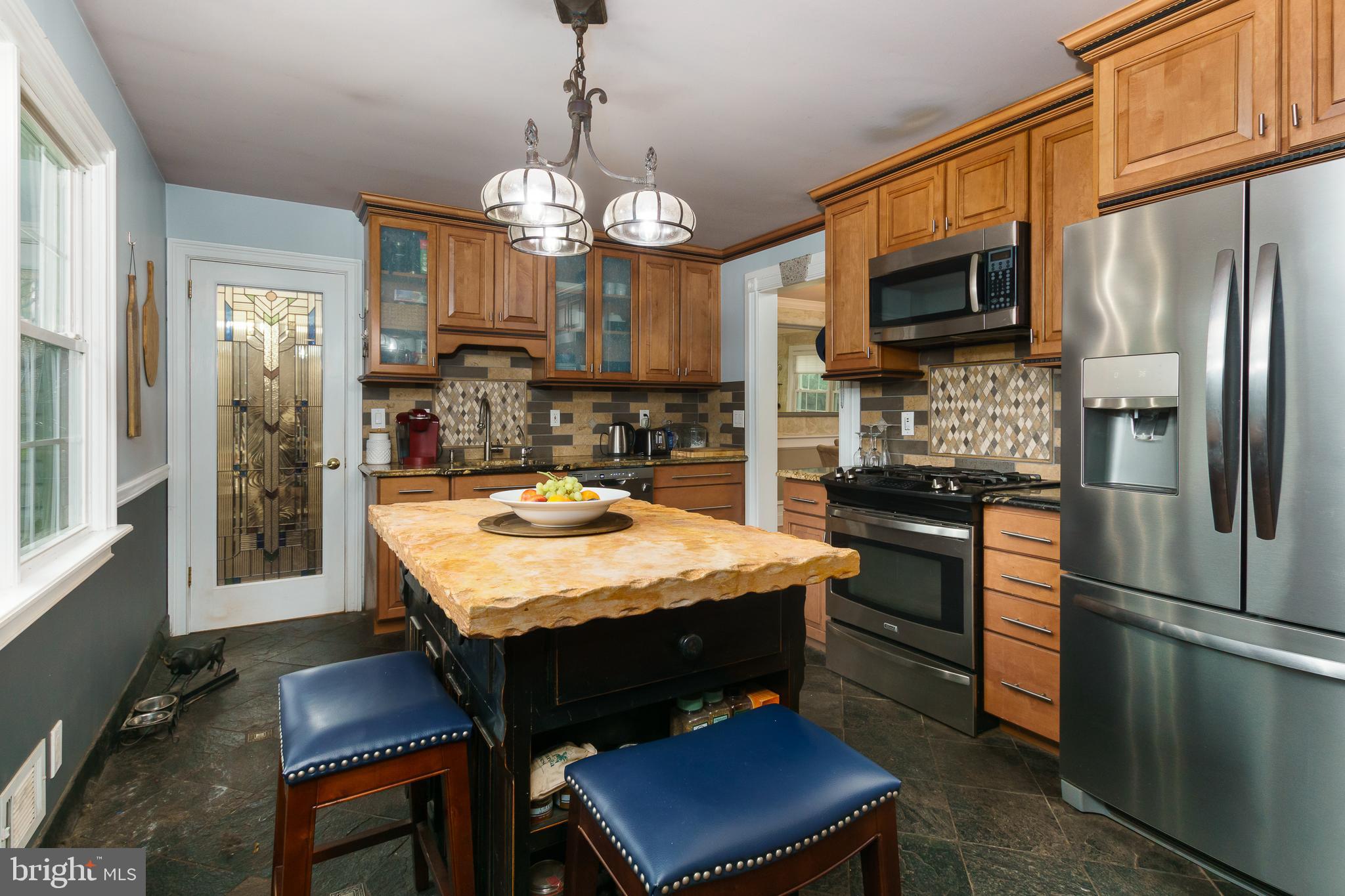 50 Skillman Road Skillman, NJ 08558 - Photo 9 of 31 a kitchen with stainless steel appliances granite countertop a sink refrigerator stove and microwave