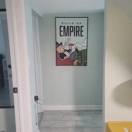 a bathroom with a painting on the wall and shower