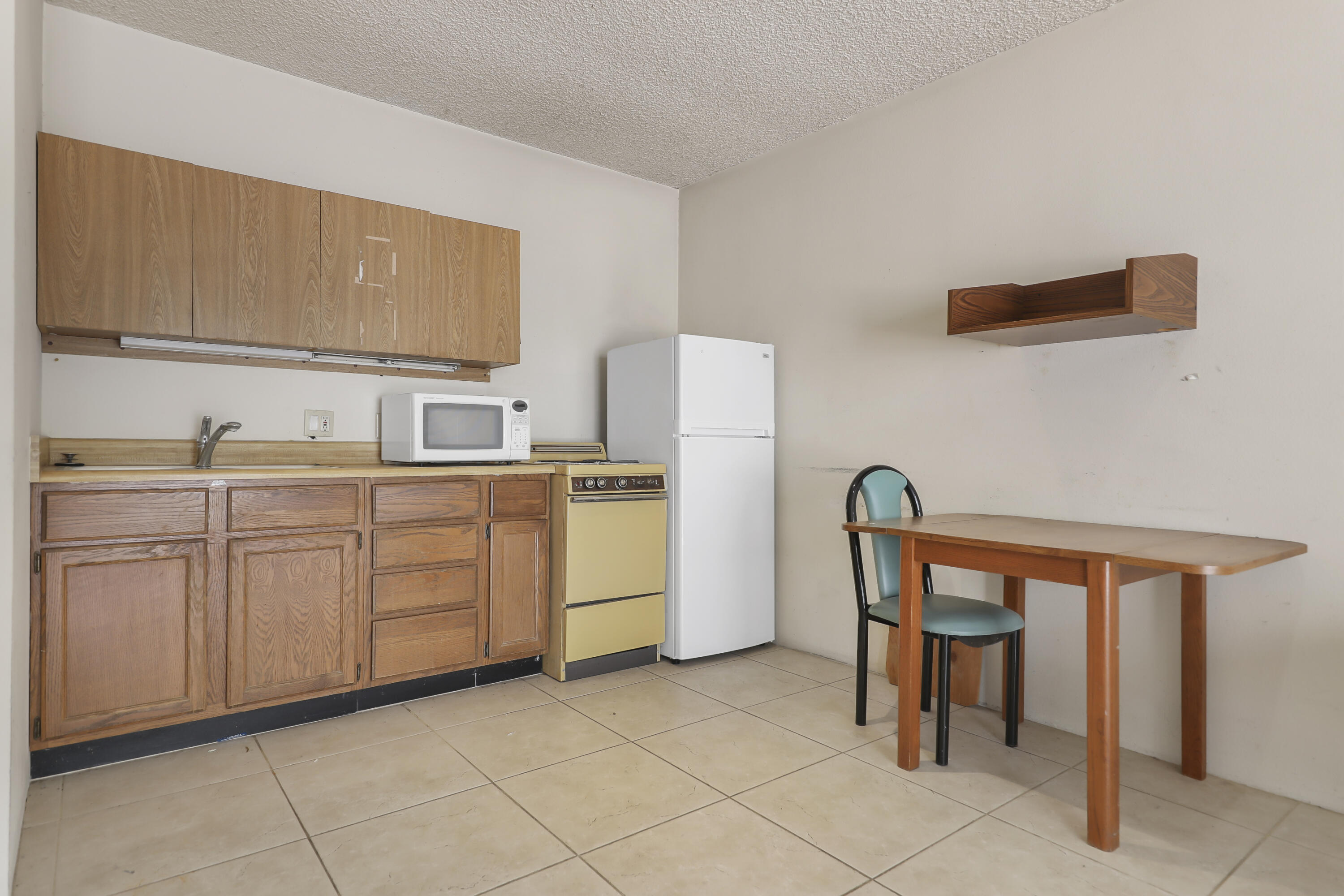 770 South La Mirada Road Palm Springs, CA 92264 - Photo 10 of 39 a kitchen with cabinets and chairs