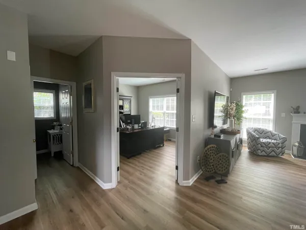 a view of entryway and hall with wooden floor