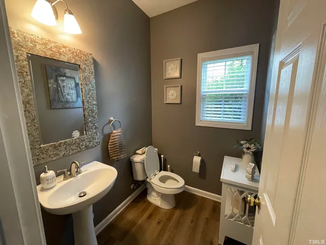 a en suite bathroom with a granite countertop tub a sink and a large mirror