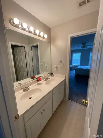 a bathroom with a tub sink and mirror