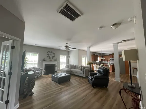 a living room with furniture and wooden floor