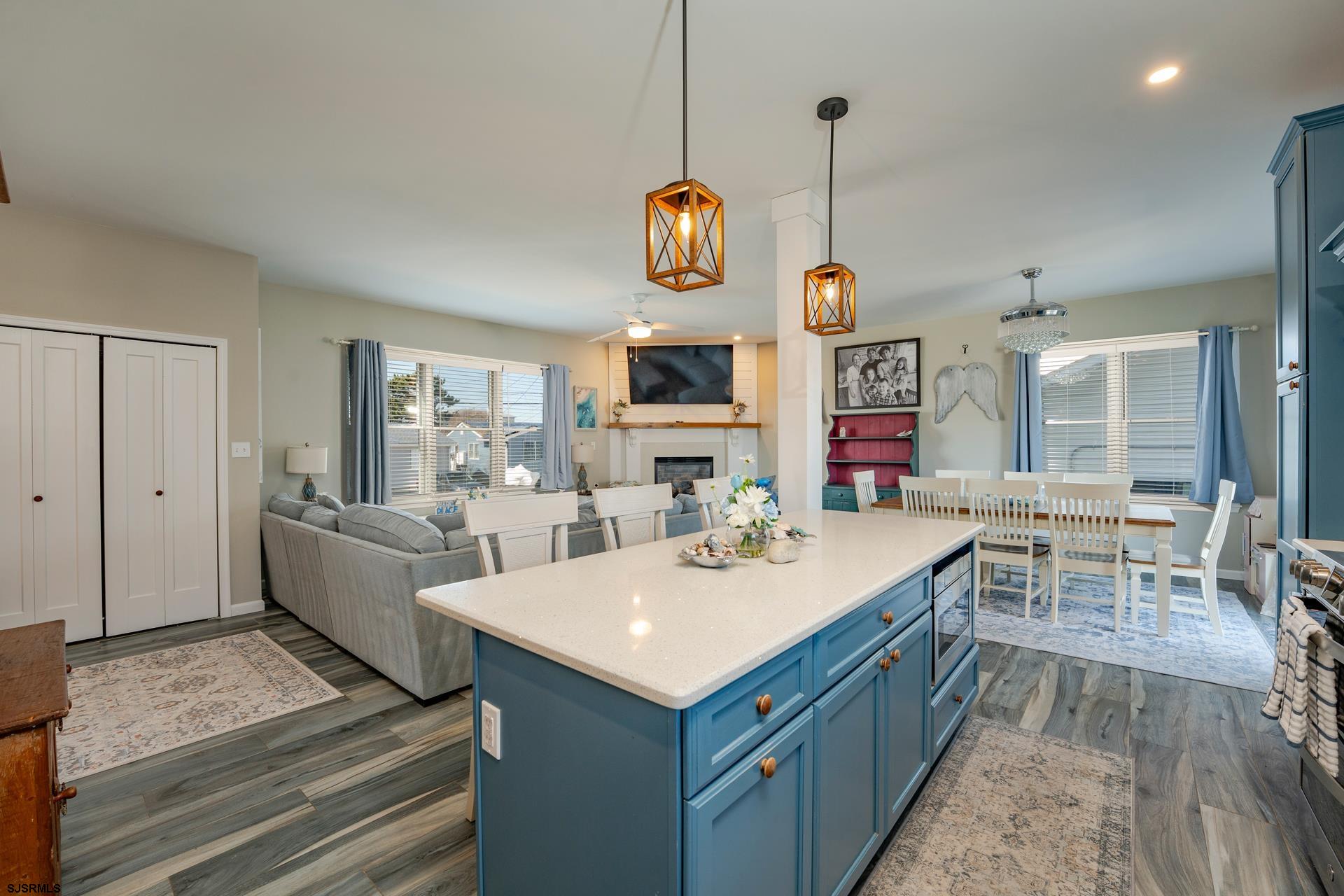 703 Bobby Jones Road Brigantine, NJ 08203 - Photo 5 of 34 a view of living room with kitchen island stainless steel appliances wooden floor and window