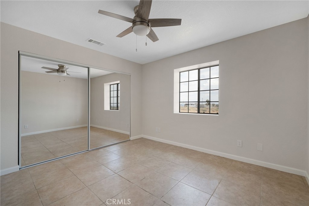 9846 Sunny Vista Road Phelan, CA 92371 - Photo 21 of 34 a view of an empty room with a window