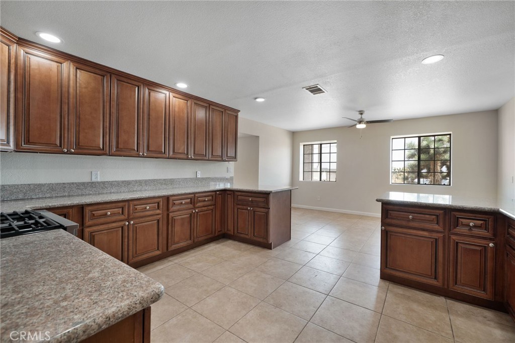 9846 Sunny Vista Road Phelan, CA 92371 - Photo 8 of 34 a kitchen with stainless steel appliances granite countertop wooden cabinets a sink and dishwasher