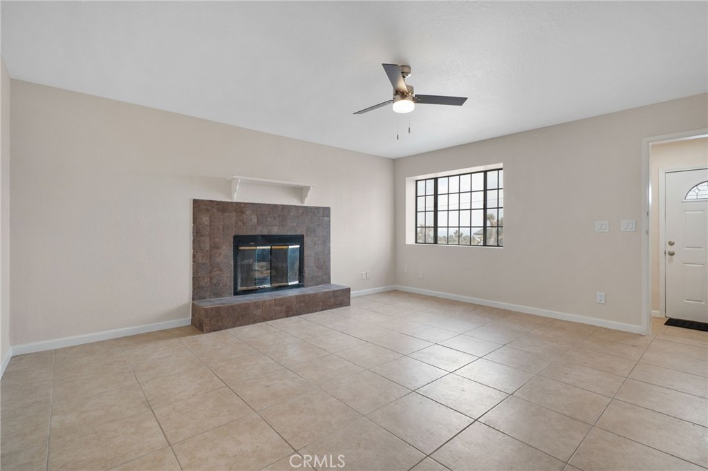 9846 Sunny Vista Road Phelan, CA 92371 - Photo 10 of 34 a view of an empty room with chandelier fan and fire place