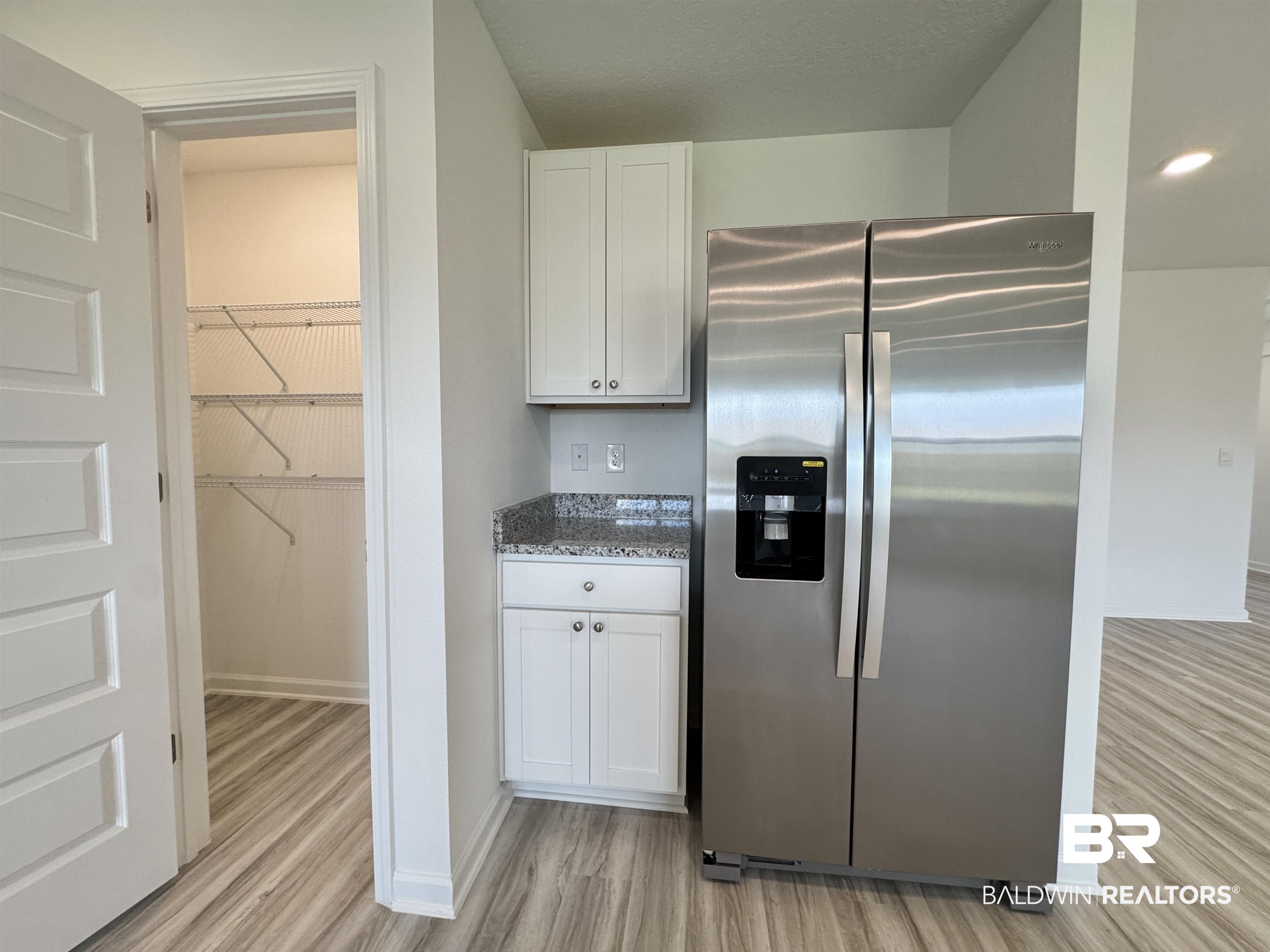 22072 Aleutian Avenue Foley, AL 36535 - Photo 8 of 47 Kitchen featuring stainless steel refrigerator with ice dispenser, walk in pantry with shelving and room to add more shelves.