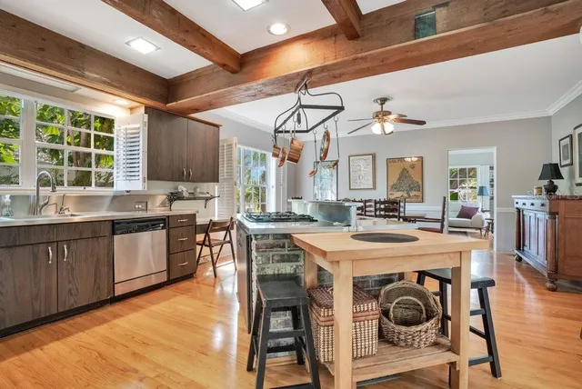 a kitchen with a sink a counter space appliances and cabinets